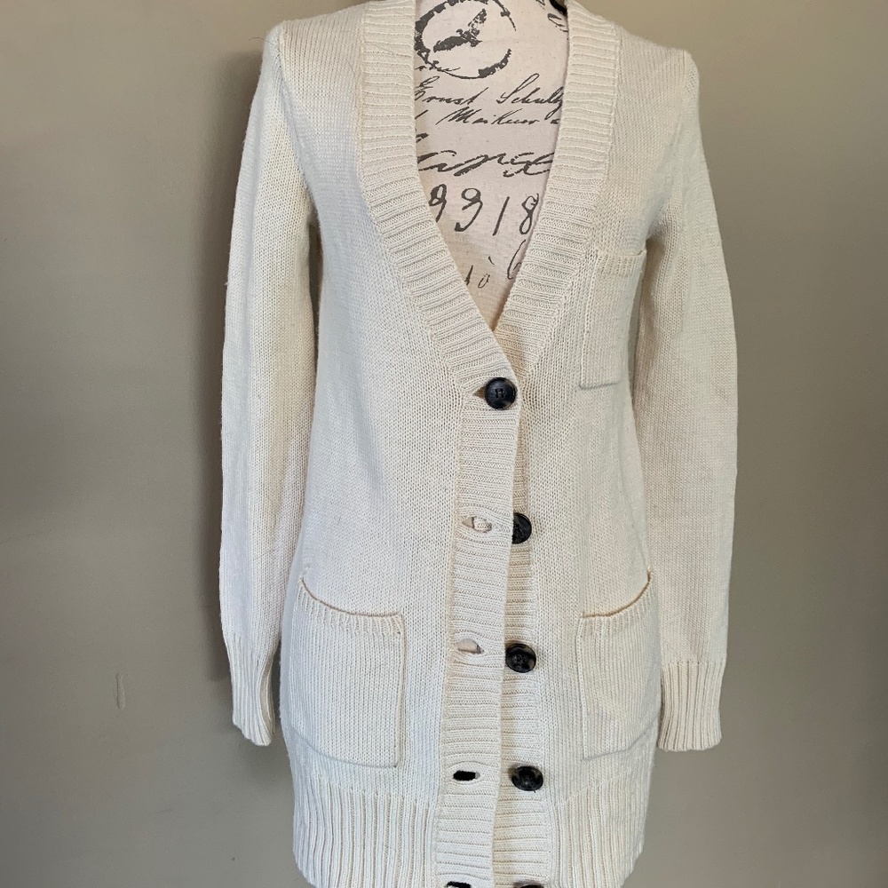 Cream colored cardigan with front pockets